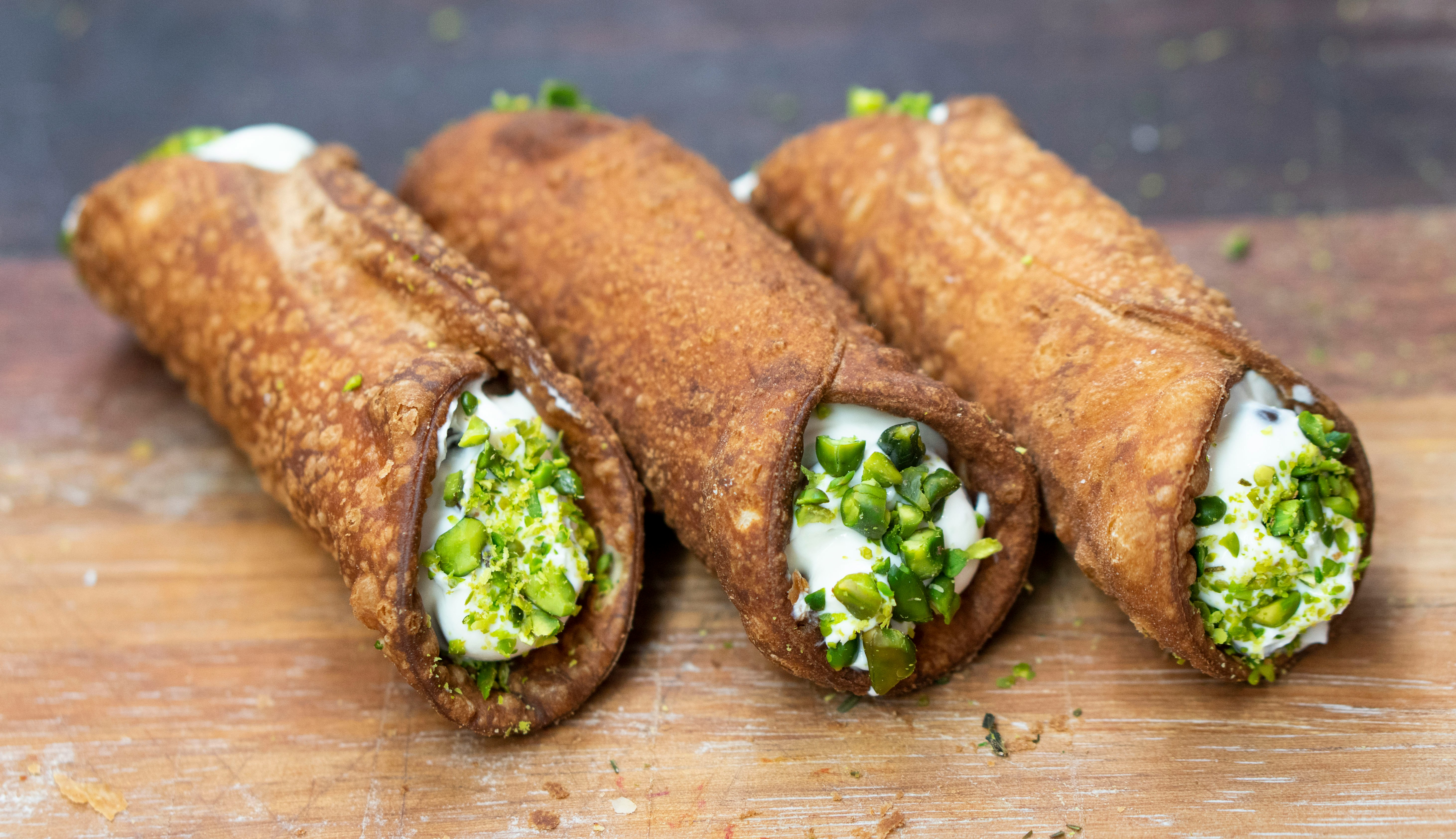 A vibrant spread of classic Sicilian foods: arancini, cannoli, caponata, and more